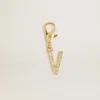 Letter V charm in gold-colored brass with crystals