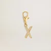 Letter X charm in gold-colored brass with crystals