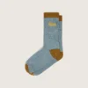 Light blue ribbed socks with brown details and yellow logo