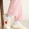 May Young with fuchsia glitter star and metallic leather heel tab