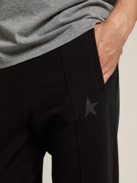 Men’s black joggers with star on the front