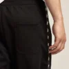 Men's black joggers with white stars on the sides