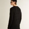 Men's black wool sweater with a distressed effect