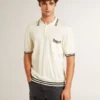 Men's worn-white knitted polo shirt with blue ribbing