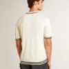 Men's worn-white knitted polo shirt with blue ribbing