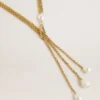 Necklace with antique gold-colored chains with pearls