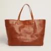 Pasadena Bag in tan-colored glossy hammered leather with gold logo on the front