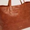 Pasadena Bag in tan-colored glossy hammered leather with gold logo on the front