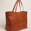 Pasadena Bag in tan-colored glossy hammered leather with gold logo on the front