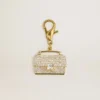 Purse-shaped charm in gold-colored brass with crystals