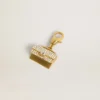Purse-shaped charm in gold-colored brass with crystals