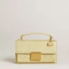 Purse-shaped charm in gold-colored brass with crystals