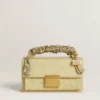 Purse-shaped charm in gold-colored brass with crystals