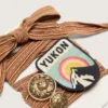 Skins burgundy and peach embroidered laces with patch and two charms