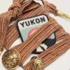 Skins burgundy and peach embroidered laces with patch and two charms