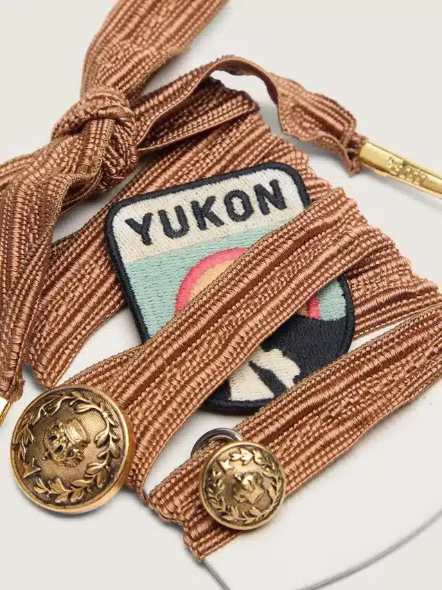 Skins burgundy and peach embroidered laces with patch and two charms