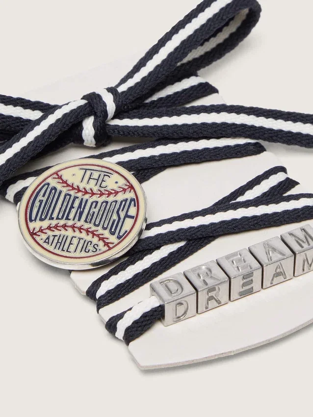 Skins cream and dark blue striped laces with pin and silver appliqué