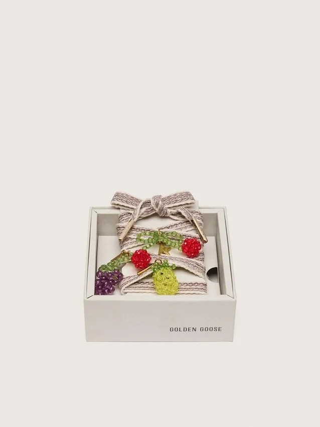 Skins cream and dove-gray striped embroidered laces with three fruit beaded charms