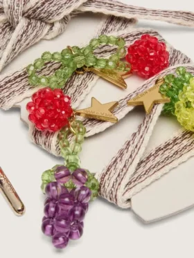 Skins cream and dove-gray striped embroidered laces with three fruit beaded charms