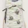 Skins green and white striped laces with jewel charms