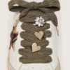Skins in sage-green wool with three jewel appliqués