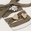 Skins in sage-green wool with three jewel appliqués
