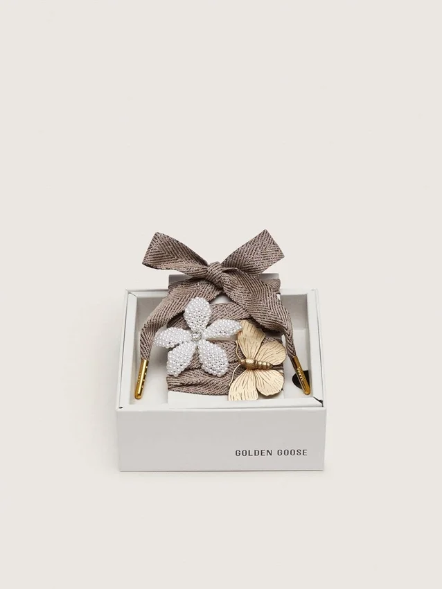 Skins "Sparkling" brown, black and silver herringbone laces with two appliqué charms