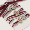 Skins white and burgundy striped laces embellished with charms