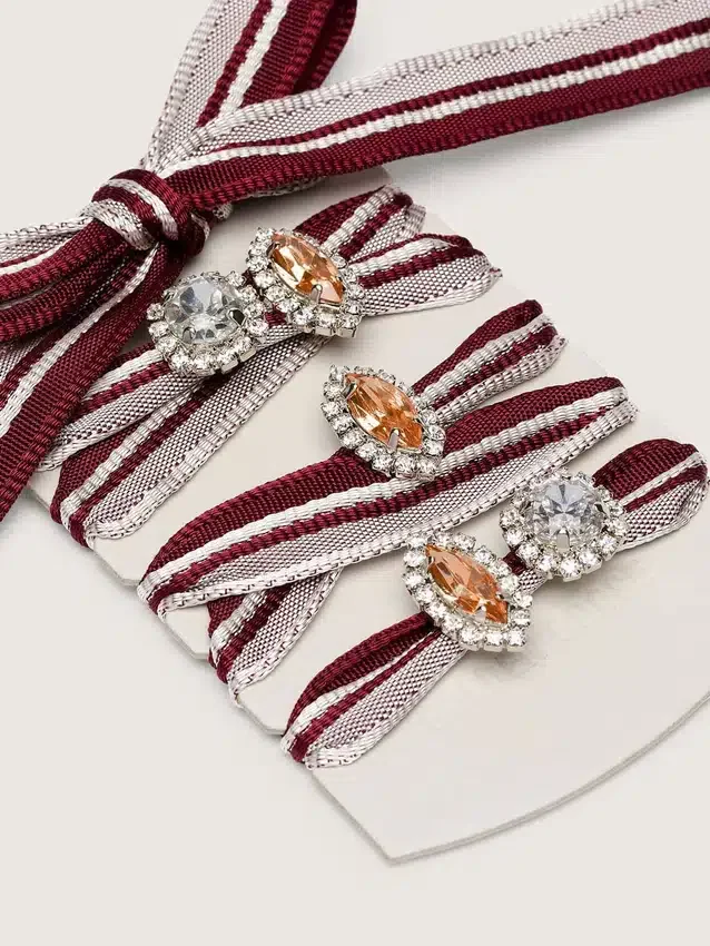 Skins white and burgundy striped laces embellished with charms