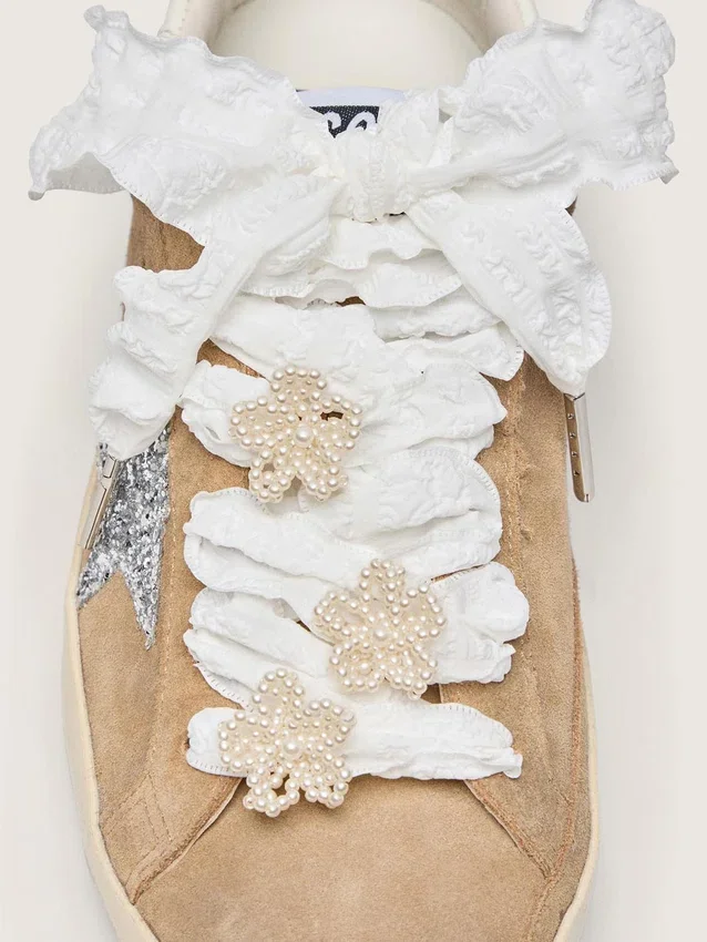 Skins white crinkle laces with flower-shaped beaded appliqués