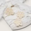 Skins white crinkle laces with flower-shaped beaded appliqués