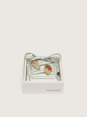 Skins white laces with forest-green embroidery and strawberry pins