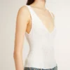 Sleeveless top embroidered with worn-white ribbing