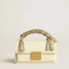 Small Venezia Bag in butter-colored boarded leather with braided scarf and double charm