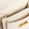 Small Venezia Bag in butter-colored boarded leather with braided scarf and double charm