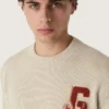 Unisex crew-neck sweater in beige cotton with patch on the front and logo on the back