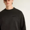 Unisex sweatshirt in worn black cotton with logo embroidery