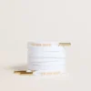 White cotton laces with contrasting gold logo