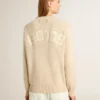 Women's beige sweater with 'Golden' lettering on the back