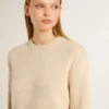 Women's beige sweater with 'Golden' lettering on the back