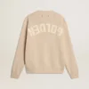 Women's beige sweater with 'Golden' lettering on the back