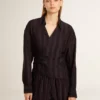 Women's black shirt with vertical stripes and side knot closure