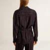 Women's black shirt with vertical stripes and side knot closure