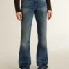 Women's bootcut jeans with a vintage wash and metallic details