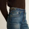 Women's bootcut jeans with a vintage wash and metallic details