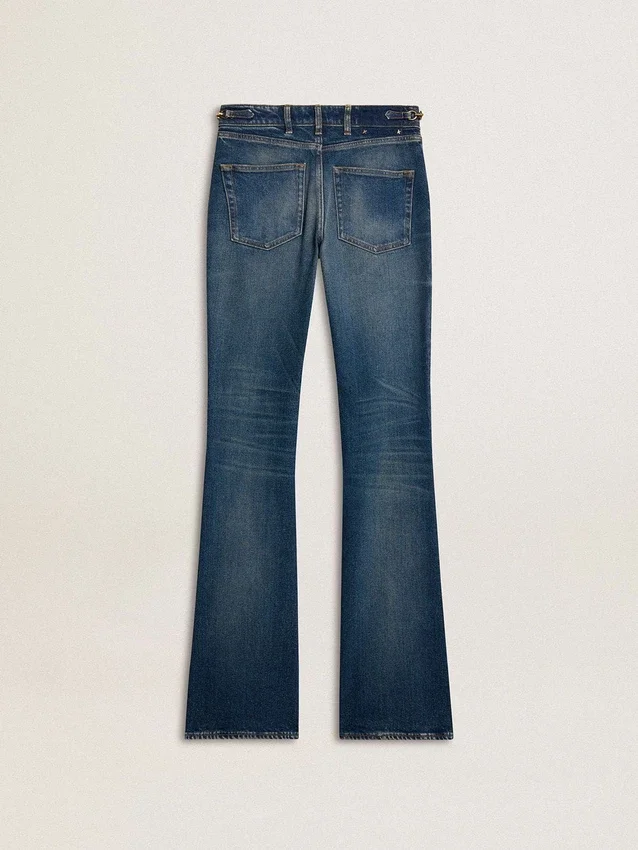 Women's bootcut jeans with a vintage wash and metallic details