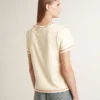 Women's cream T-shirt with faded red accents