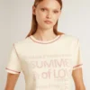 Women's cream T-shirt with faded red accents