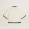Women's cropped worn-white cotton polo shirt with blue ribbing
