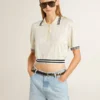 Women's cropped worn-white cotton polo shirt with blue ribbing